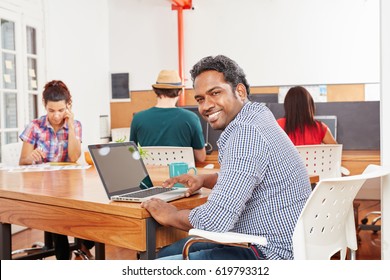 Man As Startup Founder In Coworking Office Using Laptop