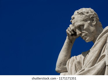 Man statue in the act of thinking against blue sky. Ancient Roman Julian the Jurist statue erected at the end of 19th century in front of the Old Palace of Justice in Rome (with copy space)