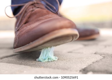 Man Stepping In Chewing Gum On Sidewalk. Concept Of Stickiness