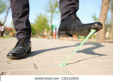 Man Stepping In Chewing Gum On Sidewalk. Concept Of Stickiness