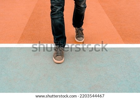 Man stepping over a white line.Walking across the start line representing business and life start up concept. Add your own motivational message. Stock photo © 