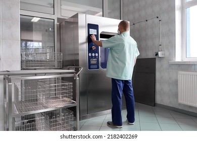 Man Sterilising Hospital Equipment With A Machine