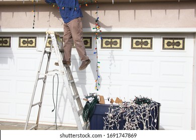 Man Stinging Christmas Lights on His House