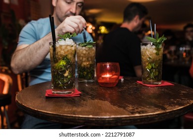 Man Stirring Cocktail In Glass