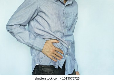 Man with stomach pain on blue background. Pain in the right side. Appendicitis. Problems with the gut and with digestion. Liver disease, Fibrosis , Inflammation, Lymphoma