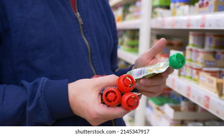 A Man In A Store Chooses Baby Food For His Child, A Customer Chooses The First Complementary Food For A Child On The Shelf. A Single Father Will Buy Food For His Little Child.