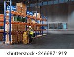 Man storekeeper. Customs officer near racks of boxes. Storekeeper with tablet keeps track of goods. Man standing in storage hangar. Customs warehouse. Storekeeper registers goods in application