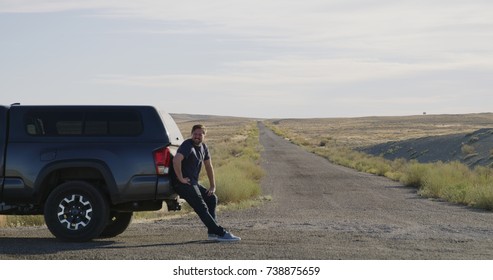 Man Stranded Next To Truck In Middle Of Desert