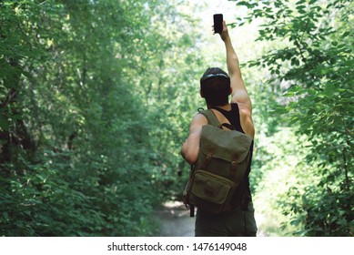 Man Is Stray In A Forest And Is Trying To Call Mobile Phone But No Signal Concept.