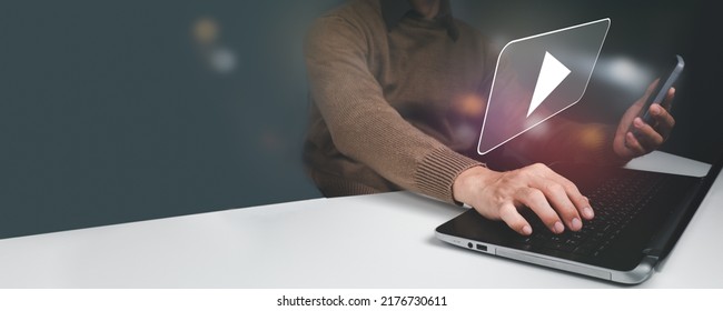 A man is streaming online, seeing movies on the internet, or attending a live performance, show, or instruction on his mobile phone. Online live streaming video marketing concept, - Shutterstock ID 2176730611