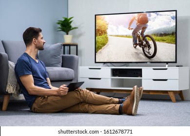 Man Streaming Television Channel Through Wireless Connection On Digital Tablet