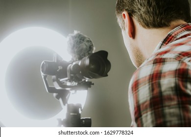 A Man Streaming, Video Recording Using A Mirrorless Camera And Ring Light.