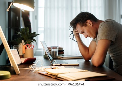 Man stressed while working on laptop - Shutterstock ID 796181494