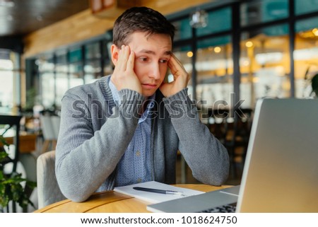 Man stressed while working on laptop