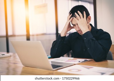 The man are stressed at work in the office. Asian businessman stressful and headache with laptop computer. Young male with headache at office, feeling sick at work. - Shutterstock ID 1750229966
