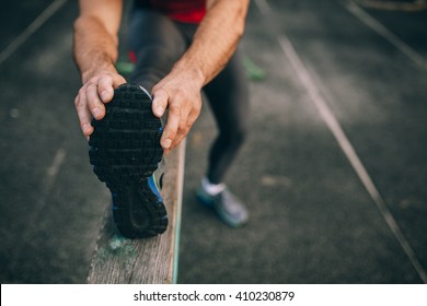 man stretches the body before running - Powered by Shutterstock