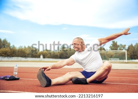 Similar – Jogger stretching in the morning on seaside.