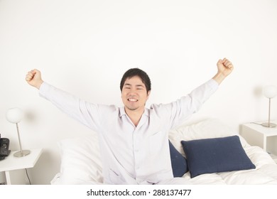 Man stretching after wake up - Shutterstock ID 288137477