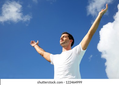 Man Stretching Arms Up Towards The Sky