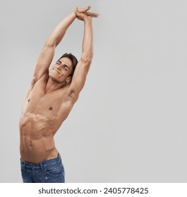 Man, stretching and fitness pride in studio, relaxing and smiling by gray background. Male person, wellness and confidence for healthy body, muscle development and results or progress by mockup space - Powered by Shutterstock