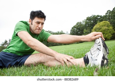 Man Stretching His Leg Outdoors