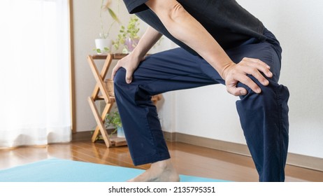 A Man Stretching At Home. Stretched Legs:Open Legs:Hamstring Stretch