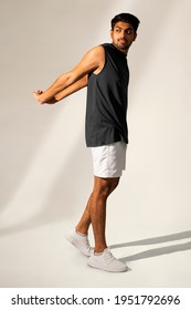 Man Stretching In Navy Tank Top And Shorts Sportswear Apparel Full Body