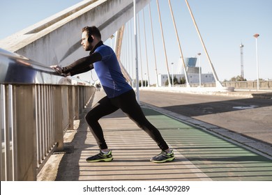 man stretching on a bridge railing. sport concept - Powered by Shutterstock