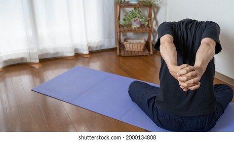 A Man Stretching In The Room.stretch To Increase The Flexibility Of The Muscles Around Shoulder Blades.stretch To Improve Your Shoulder Range Of Motion.