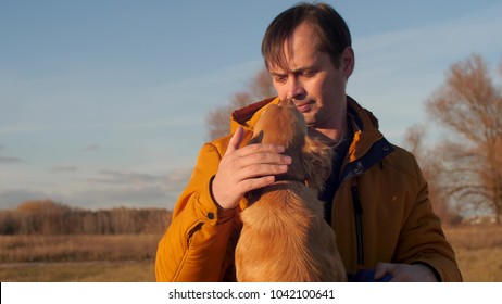 Man Is Stroking Dog. Slow Motion.