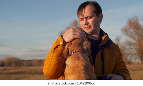 Man Is Stroking Dog. Slow Motion.