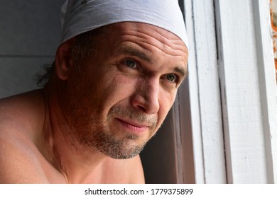 Man With Stubble And Dusty Face Looks Out The Window