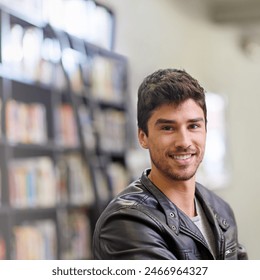 Man, student and portrait in library for education or learning, books for knowledge at university. Male student, campus and smile in study room for information, bright future at college in Chicago