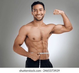 Man, studio and measuring tape for flex, fitness and weight loss with health and exercise. Guy, workout and results for training, body and diet with muscle and topless athlete on grey background - Powered by Shutterstock
