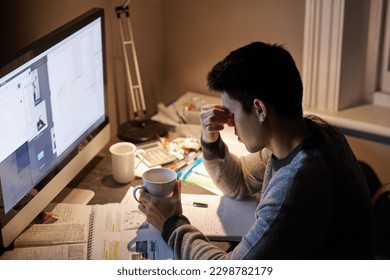 Man, studying and headache in night by computer for test, assessment or stress in college dorm room. Male university student, tea cup or burnout with anxiety, fatigue or tired with books for learning - Powered by Shutterstock