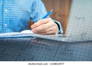 man is studying for his exam. Solving math problems to practice. Studying exact sciences such as mathematics or physics - Shutterstock ID 2138014977