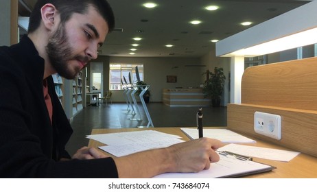 A man is studying at library.