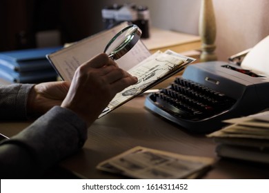 A man is studying old documents. Vintage documents, retro investigation, treasure search, discovery concept.