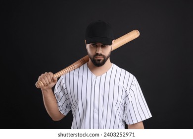 Man in stylish baseball cap holding bat on black background - Powered by Shutterstock