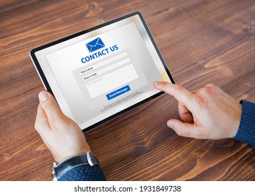 Man submitting contact form on website - Shutterstock ID 1931849738