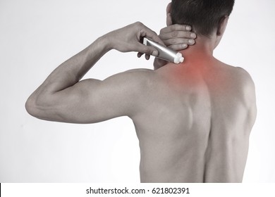 Man Suffering From Back Pain Applying Pain Relief Cream . Sports Exercising Injury.