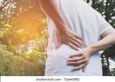 A man suffering from backache, spinal injury and muscle issue problem at outdoor.