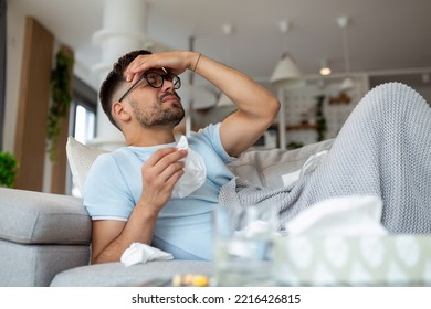 man suffering from covid-19 symptoms lying on bed at home, high fever and coughing prevent him from living a normal life, he has to be on self-isolation. stay home