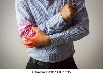 Man Suffering From Elbow Joint Pain / Healthcare And Problem Concept