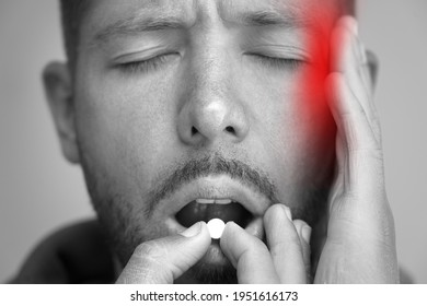 Man Suffering From Headache And Taking Painkillers To Relieve Pain. Pill Or Tablet From Migraine, Tension Or Cluster Headache