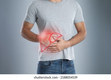 Man suffering from liver pain on grey background, closeup - Shutterstock ID 2188054539
