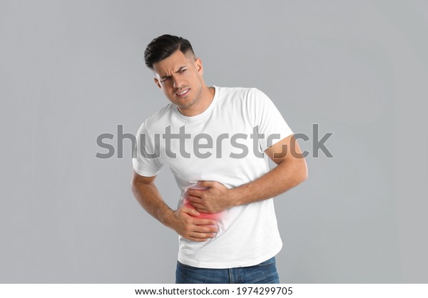 Man Suffering Liver Pain On Grey Stock Photo 1974299705 | Shutterstock