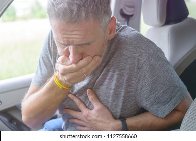 Man Suffering From Motion Sickness In A Car