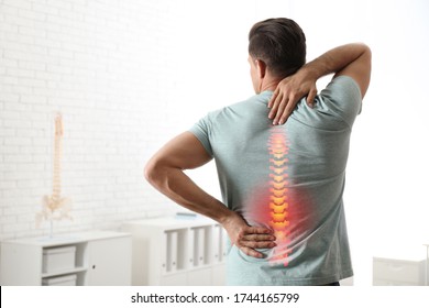 Man Suffering From Pain In Back At Clinic