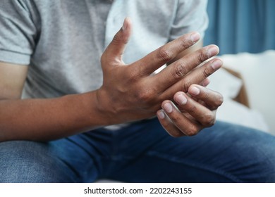 man suffering pain in hand close up  - Shutterstock ID 2202243155